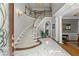 Grand foyer featuring a curved staircase, marble floors, and elegant decor creating a welcoming entrance at 2314 Edgemere Lake Cir, Marietta, GA 30062