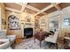This home office offers wood paneling, beamed ceilings, built-in bookshelves, and a cozy fireplace at 2314 Edgemere Lake Cir, Marietta, GA 30062