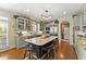 Beautiful open kitchen with island, stainless steel appliances, custom cabinets, hardwood floors, and modern lighting at 2314 Edgemere Lake Cir, Marietta, GA 30062