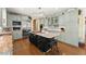 Spacious kitchen featuring a large island, stainless steel appliances, granite countertops, and custom cabinetry at 2314 Edgemere Lake Cir, Marietta, GA 30062