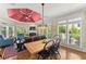 Cozy living area with dining table, large windows, comfortable seating, and fireplace, perfect for relaxing at 2314 Edgemere Lake Cir, Marietta, GA 30062