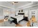 Serene main bedroom with a tray ceiling, hardwood floors, and views to the sunroom at 2314 Edgemere Lake Cir, Marietta, GA 30062