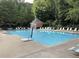 Inviting community pool surrounded by lounge chairs, umbrellas, and lush greenery at 2314 Edgemere Lake Cir, Marietta, GA 30062