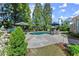 Backyard with pool, patio, grill, table and chairs, umbrellas, and mature landscaping at 2314 Edgemere Lake Cir, Marietta, GA 30062