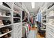 Organized walk-in closet with custom shelving, racks, and ample storage for shoes and clothing at 2314 Edgemere Lake Cir, Marietta, GA 30062