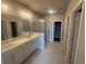 Spa-like bathroom featuring double vanity, glass shower, and modern tile floors at 315 Lakeside Ct, Canton, GA 30114