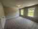 This bedroom has neutral paint, new carpet, two windows, and a closet at 315 Lakeside Ct, Canton, GA 30114