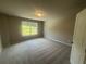 This bedroom has neutral paint, new carpet, and a window letting in lots of natural light at 315 Lakeside Ct, Canton, GA 30114