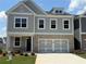 Beautiful two-story home featuring a brick and light gray facade, attached two car garage, and well-manicured lawn at 315 Lakeside Ct, Canton, GA 30114