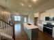 Open-concept living room flows into a modern kitchen with stainless steel appliances and center island at 315 Lakeside Ct, Canton, GA 30114