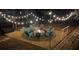 Cozy backyard fire pit area with comfortable seating and ambient string lights at 315 Monroe Dr, Mcdonough, GA 30252