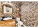 Unique powder room featuring designer wallpaper and a custom vanity at 315 Monroe Dr, Mcdonough, GA 30252