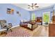 Cozy bedroom with wood floors, comfortable chair, a ceiling fan, and a pull out bed at 315 Monroe Dr, Mcdonough, GA 30252