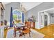 Elegant dining room with large window, chandelier, and hardwood floors, perfect for entertaining at 315 Monroe Dr, Mcdonough, GA 30252