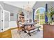 Bright dining room with vaulted ceiling, chandelier, large arched window, and classic wood furniture at 315 Monroe Dr, Mcdonough, GA 30252
