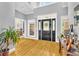 Inviting foyer featuring hardwood floors, high ceilings, and a striking black front door with decorative glass at 315 Monroe Dr, Mcdonough, GA 30252