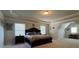 This bedroom features an attached room, tray ceiling and large windows for plenty of natural light at 5530 Lacebark Pine Ct, Cumming, GA 30040