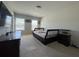 Bedroom with two windows, light carpet and a large black bed frame at 5530 Lacebark Pine Ct, Cumming, GA 30040
