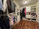 Walk-in closet with custom shelving, and wood flooring at 5530 Lacebark Pine Ct, Cumming, GA 30040