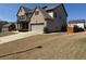 Spacious home with attached two-car garage and a long driveway leading to the backyard at 5530 Lacebark Pine Ct, Cumming, GA 30040