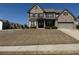 Charming two-story brick home with a well-maintained lawn and attached two-car garage at 5530 Lacebark Pine Ct, Cumming, GA 30040