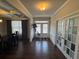 Bright foyer with hardwood floors, French doors and view to the dining room at 5530 Lacebark Pine Ct, Cumming, GA 30040