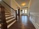 Bright and spacious foyer with hardwood floors, staircase, and decorative molding at 5530 Lacebark Pine Ct, Cumming, GA 30040