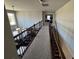 Upstairs hallway features a carpeted floor, and a view of the living room below at 5530 Lacebark Pine Ct, Cumming, GA 30040