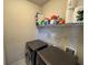 Neat laundry room with stacked washer and dryer and wire shelf at 5530 Lacebark Pine Ct, Cumming, GA 30040