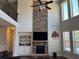 Bright living room featuring tall windows, fireplace, and open layout at 5530 Lacebark Pine Ct, Cumming, GA 30040