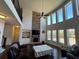 Bright living room featuring tall windows, fireplace, and open layout at 5530 Lacebark Pine Ct, Cumming, GA 30040