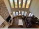 Aerial view showcasing the living room with its high ceilings and abundant natural light from large windows at 5530 Lacebark Pine Ct, Cumming, GA 30040