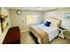 Comfortable bedroom with neutral tones, a plush bed, and natural light from the window at 8562 Lake Dr, Snellville, GA 30039