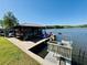 Dock with boat slip and multiple watercrafts, offering waterfront access at 8562 Lake Dr, Snellville, GA 30039