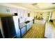 Modern kitchen with stainless steel appliances, granite countertops, and a breakfast bar overlooking the dining area at 8562 Lake Dr, Snellville, GA 30039
