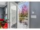 Back porch area with glass door, seating, and view of blooming backyard plants at 1324 Cambridge Ave. Sw, Atlanta, GA 30344