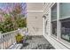 Back porch with a flower pot and seating overlooking trees in bloom at 1324 Cambridge Ave. Sw, Atlanta, GA 30344