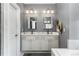 Modern bathroom features double sinks, white cabinets, and well-lit mirrors, creating a clean, and functional space at 1324 Cambridge Ave. Sw, Atlanta, GA 30344