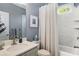 Clean bathroom with a shower-tub combo, white marble-style tile, and modern fixtures at 1324 Cambridge Ave. Sw, Atlanta, GA 30344