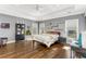 Spacious bedroom with tray ceilings, hardwood floors, and multiple windows offering plenty of natural light at 1324 Cambridge Ave. Sw, Atlanta, GA 30344