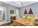 Bright bedroom features a ceiling fan, hardwood floors, and stylish decor, creating a relaxing and inviting space at 1324 Cambridge Ave. Sw, Atlanta, GA 30344