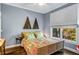 Bedroom featuring a floral-patterned bedspread and a window view at 1324 Cambridge Ave. Sw, Atlanta, GA 30344