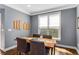 Dining room with a table and four chairs, natural light from a large window at 1324 Cambridge Ave. Sw, Atlanta, GA 30344