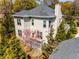 Two-story home showcasing its back facade, gray roof, lush surrounding trees, and private back deck at 1324 Cambridge Ave. Sw, Atlanta, GA 30344