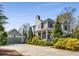 The home's exterior view reveals a two-car garage, covered porch, driveway, and manicured landscaping at 1324 Cambridge Ave. Sw, Atlanta, GA 30344