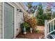 Charming home entrance with a gray-green door, lovely landscaping, and inviting outdoor decor at 1324 Cambridge Ave. Sw, Atlanta, GA 30344