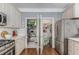 Charming kitchen with stainless steel refrigerator, white cabinets, and walk-in pantries at 1324 Cambridge Ave. Sw, Atlanta, GA 30344