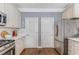 This kitchen features stainless steel appliances, white cabinets, and wood floors at 1324 Cambridge Ave. Sw, Atlanta, GA 30344