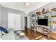 Bright living room with hardwood floors, comfortable sofa, and decorative shelving at 1324 Cambridge Ave. Sw, Atlanta, GA 30344
