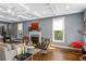 Well-lit living room featuring a fireplace, coffered ceilings, and a cozy seating arrangement at 1324 Cambridge Ave. Sw, Atlanta, GA 30344